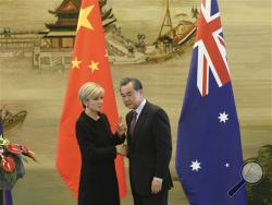 Australian Foreign Minister Julie Bishop, left, shakes hands with Chinese Foreign Minister Wang Yi during their joint press conference at the Ministry of Foreign Affairs in Beijing Wednesday, Feb. 17, 2016. China's moves to assert its sovereignty claims in the South China Sea were expected to be discussed during a visit by Bishop to Beijing on Wednesday. (Wu Hong/Pool Photo via AP)