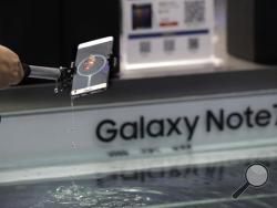 A man tries out the Samsung's latest smartphone Galaxy Note 7 at a roadshow booth outside a shopping mall in Beijing, Thursday, Sept. 1, 2016. Samsung has delayed shipments of Galaxy Note 7 smartphones in South Korea for quality control testing after reports that batteries in some of the jumbo smartphones exploded while they were being charged. (AP Photo/Andy Wong)