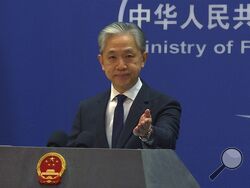 In this image made from video, Chinese Foreign Ministry spokesperson Wang Wenbin gestures during a media briefing at the Ministry of Foreign Affairs office in Beijing, Tuesday, March 14, 2023. The United States, Australia and the United Kingdom are traveling "further down the wrong and dangerous path for their own geopolitical self-interest," China's Foreign Ministry said Tuesday, responding to an agreement under which Australia will purchase nuclear-powered attack submarines from the U.S. to modernize its 