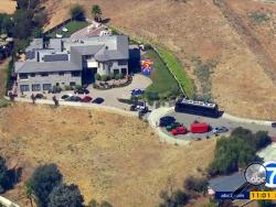This image from aerial video provided by KABC-TV shows the home of entertainer Chris Brown with a police vehicle outside, in the Tarzana area of Los Angeles Tuesday, Aug. 30, 2016. (KABC-TV via AP)