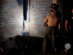 Members of the South Carolina Law Enforcement Division examine the remains of the Mount Zion African Methodist Episcopal church, early Wednesday, July 1, 2015, in Greeleyville, S.C. The African-American church, which was burned down by the Ku Klux Klan in 1995, caught fire Tuesday night, June 30, 2015. (Veasey Conway/The Morning News via AP) Members of the South Carolina Law Enforcement Division examine the remains of the Mount Zion African Methodist Episcopal church, early Wednesday, July 1, 2015, in Greeleyville, S.C. The African-American church, which was burned down by the Ku Klux Klan in 1995, caught fire Tuesday night, June 30, 2015. (Veasey Conway/The Morning News via AP)