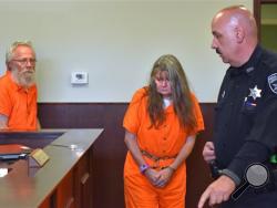 Bruce Leornard, left, and Deborah Leonard, center, enter the courtroom of before their arraignment, Tuesday, Oct. 13, 2015 in New Hartford, N.Y. The central New York couple have been charged with fatally beating their 19-year-old son inside a church, and four fellow church members have been charged with assault in an attack that also left the young man's brother severely injured, police said Tuesday. (Mark DiOrio/Observer-Dispatch via AP)