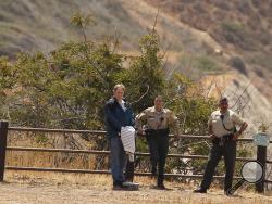 In this May 7, 2015, file photo, defendant Cameron Brown, left, and Los Angeles County sheriff deputies, watch as jurors make a site visit to the Abalone Cove and Portuguese Bend areas during his third trial in Rancho Palos Verdes, Calif. (Al Seib/Los Angeles Times via AP, Pool, File)