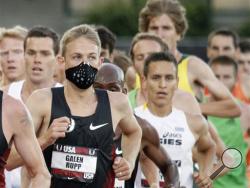 In this June 23, 2011 file photo, a runner wears a mask for allergies during the U.S. track and field championships in Eugene, Ore. A report issued Monday, April 4, 2016, by the Obama Administration listed how global warming will make the air dirtier, water more contaminated and food more tainted. It warned of diseases, such as those spread by ticks and mosquitoes, longer allergy seasons, and thousands of heat wave deaths. (AP Photo/Don Ryan, File)