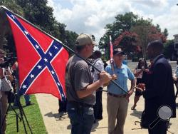 Randy Saxon, left and Wayne Whitfield, both of Anderson, S.C., discuss the Confederate flag on the South Carolina Statehouse grounds with Brodrick S. Hall of Atlanta, right, on Monday, July 6, 2015. Lively discussions on the flag took place on the grounds took place outside the state house where lawmakers debated whether the flag should be removed from the downtown Columbia complex. ( AP Photo/ Meg Kinnard)