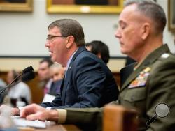 Defense Secretary Ash Carter, left, accompanied by Joint Chiefs Chairman Gen. Joseph Dunford Jr., testifies on Capitol Hill in Washington, Tuesday, Dec. 1, 2015, before the House Armed Services Committee hearing on the U.S. Strategy for Syria and Iraq and its Implications for the Region. (AP Photo/Andrew Harnik)