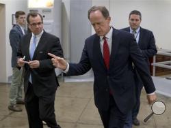 Sen. Patrick Toomey, R-Pa., center, walks towards the Senate on Capitol Hill, Monday, June 20, 2016 in Washington. A divided Senate hurtled Monday toward an election-year stalemate over curbing guns, eight days after Orlando's mass shooting horror intensified pressure on lawmakers to act but left them gridlocked anyway — even over restricting firearms for terrorists. (AP Photo/Alex Brandon)