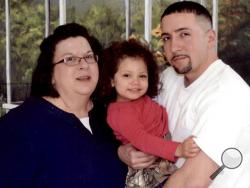 his March 2015 photo provided by the family shows Lisa Ladd, left, and her son, Corey, with his daughter, Charlee, at the Elayn Hunt Correctional Center in St. Gabriel, La. Ladd, who _ because he had two prior drug arrests _ is serving a 17-year sentence in Louisiana for possessing a half-ounce of marijuana. He has never seen Charlee outside prison; she's being raised by her grandmother. (Courtesy Lisa Ladd via AP)