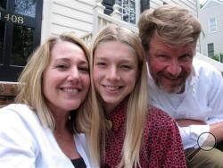 Hunter Schafer poses with parents Katy and Mac on the front porch of their Raleigh, N.C., home on Friday, May 13, 2016. The 17-year-old transgender youth is a plaintiff in a lawsuit against North Carolina's recently enacted House Bill 2, which overturned LGBT protections put in place by the city of Charlotte. (AP Photo/Allen G. Breed)