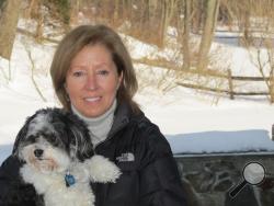 In this Feb. 19, 2015 photo, Ann Styles Brochstein holds her Havanese dog Samson near where Samson was attacked by a coyote outside her home in Chappaqua, N.Y. (AP Photo/Jim Fitzgerald) 