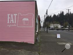 This photo shows the outside of Fat Cupcake, Monday, Oct. 10, 2016 in Portland, Ore. Fat Cupcake, a bakery, is being accused of racism for selling an Oreo cupcake they named "Mr. President." (Lizzy Acker/The Oregonian via AP)