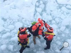 In a photo provided by the crew of Coast Guard Cutter Neah Bay, home-ported in Cleveland, Ohio, rescues a 25-year-old man attempting to walk across Lake St. Clair, March 5, 2015. (AP Photo/U.S. Coast Guard, Lt. Josh Zike)