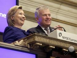  In this Sept. 21, 2009 file photo, then-Secretary of State Hillary Rodham Clinton, rings the New York Stock opening bell, accompanied by then-NYSE CEO Duncan L. Niederauer, in New York. (AP Photo/Richard Drew, File)