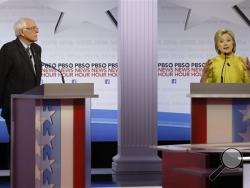 Democratic presidential candidate, Hillary Clinton, right, makes a point as Sen. Bernie Sanders, I-Vt, listens during a Democratic presidential primary debate at the University of Wisconsin-Milwaukee, Thursday, Feb. 11, 2016, in Milwaukee. (AP Photo/Morry Gash)