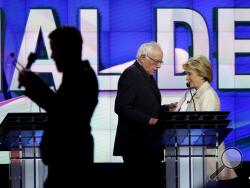 Democratic presidential candidates Sen. Bernie Sanders, I-Vt., left, and Hillary Clinton pass during a break at the CNN Democratic Presidential Primary Debate at the Brooklyn Navy Yard on Thursday, April 14, 2016 in New York. (AP Photo/Seth Wenig)