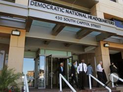 In this June 14, 2016 file photo, people stand outside the Democratic National Committee (DNC) headquarters in Washington. The computers of the House Democratic campaign committee have been hacked, an intrusion that investigators say resembles the recent cyber breach of the Democratic National Committee for which the Russian government is the leading suspect. (AP Photo/Paul Holston, File)
