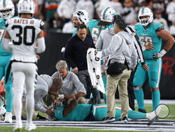 Miami Dolphins quarterback Tua Tagovailoa is examined during the first half of the team's NFL football game against the Cincinnati Bengals, Thursday, Sept. 29, 2022, in Cincinnati. (AP Photo/Jeff Dean)