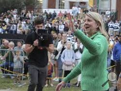 Baylor University President Linda Livingstone waves to a crowd during their annual homecoming parade, Aug., 22, 2022, in Waco, Texas. The NCAA hopes a federal appeals court will block a lawsuit that seeks to treat student-athletes as employees who are paid for their time in the latest challenge to amateurism in college sports. Livingston, chairperson of the NCAA's Board of Governors, said the idea would have a "potentially catastrophic impact on college sports.” (Rod Aydelotte/Waco Tribune-Herald via AP)