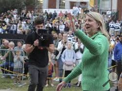 Baylor University President Linda Livingstone waves to a crowd during their annual homecoming parade, Aug., 22, 2022, in Waco, Texas. The NCAA hopes a federal appeals court will block a lawsuit that seeks to treat student-athletes as employees who are paid for their time in the latest challenge to amateurism in college sports. Livingston, chairperson of the NCAA's Board of Governors, said the idea would have a "potentially catastrophic impact on college sports.” (Rod Aydelotte/Waco Tribune-Herald via AP)