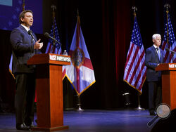 Florida's Republican Gov. Ron DeSantis, left, speaks during a debate with his Democratic opponent Charlie Crist in Fort Pierce, Fla., Monday, Oct. 24, 2022. (Crystal Vander Weit/TCPalm.com via AP, Pool)
