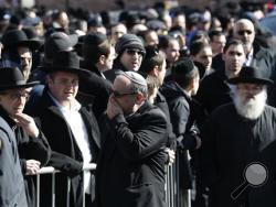 Mourners attend funeral services for the seven siblings killed in a house fire, Sunday, March 22, 2015, in the Brooklyn borough of New York. (AP Photo/Julio Cortez)