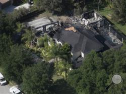 This aerial photo shows the burned out home on Thursday, May 8, 2014 in Tampa, Fla. Authorities have said they think the fire at the five-bedroom home was intentionally set and that they found fireworks inside the home. Police have not said how the blaze started or who might be responsible. (AP Photo)
