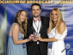 TV journalist Dylan Lyons, 24, poses for a photo with his girlfriend, left, and mom at the Florida Association of Broadcast Journalists awards ceremony on May 7, 2022 in Orlando, Fla. Lyons, a journalist with Spectrum 13 News in Orlando, was shot and killed Wednesday, Feb. 22, 2023, while covering a story about a murdered woman. (Jonathan Galed via AP)