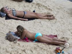 In this Aug. 5, 2014 photo, tourists and Parisians take advantage of the Paris Plage event, an artificial beach set up on the right bank of the Seine river in Paris, with palm trees, outdoor showers and hammocks. France’s summer is fast becoming a memory, and so is one of its iconic beach sights: the topless woman. (AP Photo/Jacques Brinon)