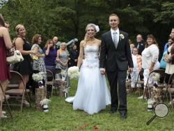 Chelsea Clair and Kyle Froelich walk down the aisle to conclude their wedding at the Danville Conservation Club. Chelsea was a stranger to Kyle when she offered to donate one of her kidneys to him in 2009. (AP Photo/The Indianapolis Star, Robert Scheer) 