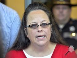 In this Sept. 14, 2015 file photo, Rowan County Clerk Kim Davis makes a statement to the media at the front door of the Rowan County Judicial Center in Morehead, Ky. (AP Photo/Timothy D. Easley, File)