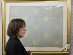 In this Thursday, June 5, 2014 photo textile conservator Virginia Whelan who recently preserved George Washington's flag, which flew to denote his presence at various battles during the war against Britain, speaks during an interview with the Associated Press at the Museum of the American Revolution's facility near Philadelphia. (AP Photo/Matt Rourke)