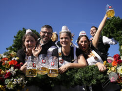 The Oktoberfest hosts arrive for the start of the 189th 'Oktoberfest' beer festival in Munich, Germany, Saturday, Sept. 21, 2024. (AP Photo/Matthias Schrader)