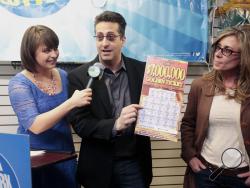 New York State Lottery draw team member Gretchen Dizer interviews Joseph Amorese of Easton, Pa., and his wife Jodi, at a store in New City, N.Y., Wednesday, March 25, 2015. (AP Photo/The Journal News, Ricky Flores) 