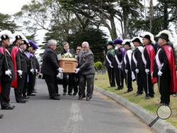 In this Saturday, June 4, 2016 photo, the Knights of Columbus, Yerba Buena Lodge of San Francisco, stand guard as the casket holding the body of a 3-year-old girl, found last month buried in San Francisco, is carried to her new grave at Greenlawn Memorial Park Cemetery in Colma, Calif. The unidentified girl, who has been named Miranda Eve, was found beneath the floor of a home being remodeled in San Francisco's Richmond District. (Michael Macor/San Francisco Chronicle via AP) 