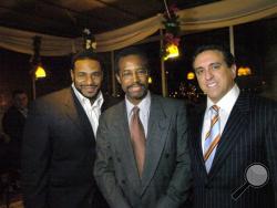 In this photo taken Dec. 1, 2005, Dr. Ben Carson, center, flanked by Dr. Al Costa, right, and then Pittsburgh Steelers running back, Jerome Bettis pose at the The Pittsburgh Carson Scholars Fund 2nd Annual Charity Auction Cocktail Event in Pittsburgh. (Andy Starnes/Pittsburgh Post-Gazette via AP)