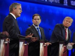 Marco Rubio, center, and Jeb Bush, left, argue a point as Donald Trump looks on during the CNBC Republican presidential debate at the University of Colorado, Wednesday, Oct. 28, 2015, in Boulder, Colo. (AP Photo/Mark J. Terrill)
