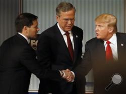 Marco Rubio and Donald Trump shake hands as Jeb Bush looks on during Republican presidential debate at Milwaukee Theatre, Tuesday, Nov. 10, 2015, in Milwaukee. (AP Photo/Morry Gash)