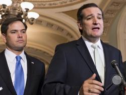 In this Sept. 27, 2013 file photo, Sen. Ted Cruz, R-Texas, right, accompanied by Sen. Marco Rubio, R-Fla., speaks on Capitol Hill in Washington. (AP Photo/J. Scott Applewhite, File)