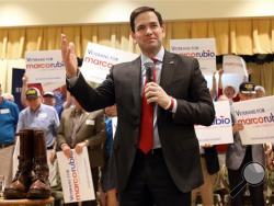 Sen. Marco Rubio, a Republican Presidential candidate, speaks during a rally with a pair of Gen. George Patton's boots beside him as veterans hold signs at the Rohan Recreation Center in The Villages, Fla. on Sunday, March 13, 2016. (Bruce Ackerman/Star-Banner via AP)