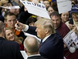 Republican presidential candidate Donald Trump gestures to the crowd as he signs autographs at a campaign event at Plymouth State University Sunday, Feb. 7, 2016, in Plymouth, N.H. (AP Photo/David Goldman)