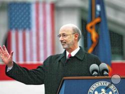 Gov. Tom Wolf waves after he took the oath of office to become the 47th governor of Pennsylvania at the state Capitol in Harrisburg. (AP Photo/Times Leader)