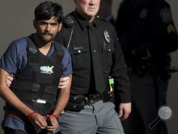 In this Nov. 28, 2012, file photo, Raghunandan Yandamuri is escorted from a Montgomery County district court after a preliminary hearing in Bridgeport, Pa. (AP Photo/Matt Rourke, File)