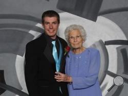 This photo provided by Inter-State Studio & Publishing Co. Shows Drew Holm and his great-grandmother Kathryn Keith in their prom picture.