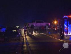 In this image made from video, people gather around a pickup truck on a flatbed truck at the scene of an accident on U.S. Highway 80 in Chunky, Miss., late Monday, Oct. 31, 2016. A vehicle struck the flat-bed trailer carrying adults and children who were dressed up for Halloween, killing three people and injuring several others, authorities said. (WTO via AP)