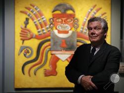 Jeffrey Quilter, Director at the Peabody Museum of Archaeology & Ethnology, poses in front of reproduction of a Peruvian Decapitator God, at Harvard University in Cambridge, Mass., Thursday, Oct. 13, 2016. The Peabody, one of the oldest and largest museums in the world focused on the study of societies and cultures, turns 150 years old this month. (AP Photo/Charles Krupa)