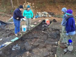 In this Nov. 19, 2014 photo made available by Bill Richardson, shows the descendants of the Hatfield and Mc Coy families clearing the homesite of Randall McCoy in Pike County, KY. The descendants are looking to uncover artifacts from the site which was set ablaze by the Hatfield clan during an attack on New Year's Day in 1888. (Bill Richardson via AP)