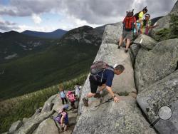In this Saturday, Aug. 7, 2015 photo, day-hikers scramble over rocky boulders on the Appalachian Trail below the summit of Mt. Katahdin in Baxter State Park in Maine. The sharp rise in the number people using the Appalachian Trail is causing headaches for officials, who say they’re dealing with increasing problems along the 2,189-mile footpath. (AP Photo/Robert F. Bukaty)