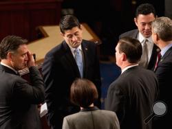 Rep. Paul Ryan, R-Wis. speaks with members of Congress in the House Chamber on Capitol Hill in Washington, Thursday, Oct. 29, 2015, before he is expected to be voted in as the new House Speaker. Rep. Jason Chaffetz, R-Utah is second from right. (AP Photo/Andrew Harnik)