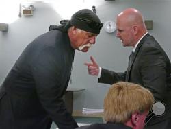 Hulk Hogan, left, whose real name is Terry Bollea, talks with attorney Shane Vogt as he appears in court Wednesday, May 25, 2016, in St. Petersburg, Fla. A Florida judge on Wednesday denied Gawker's motion for a new trial in Hogan's sex-video case and won't reduce a $140 million jury verdict. (Scott Keeler/The Tampa Bay Times via AP, Pool)