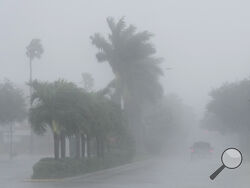 A Lee County Sheriff's officer patrols the streets of Cape Coral, Fla., as heavy rain falls ahead of Hurricane Milton, Wednesday, Oct. 9, 2024. (AP Photo/Marta Lavandier)